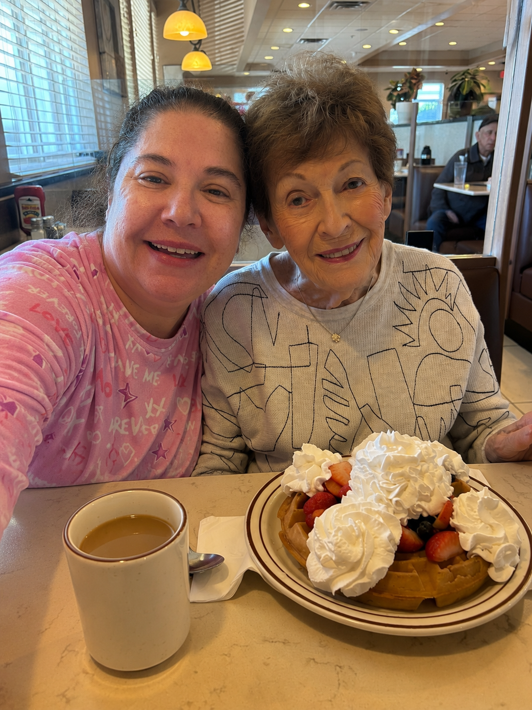 Allie sharing waffles and coffee with a client