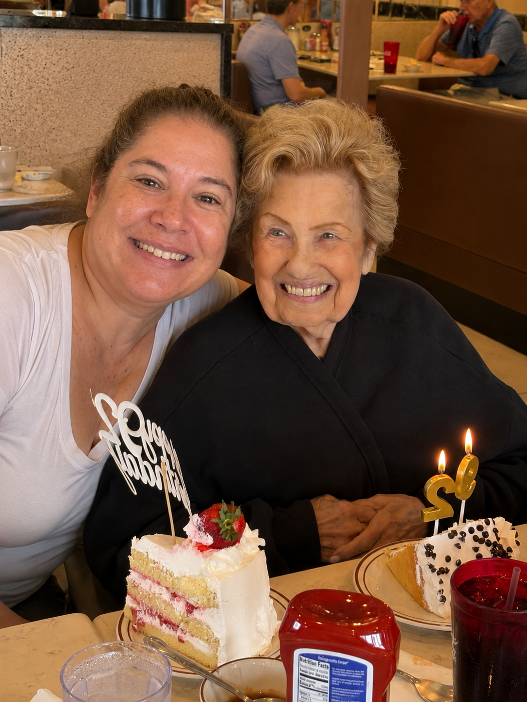 Allie celebrating a birthday with a client over cake
